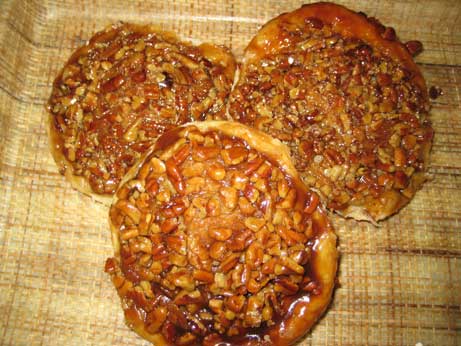 Three pecan-topped Danish on a tray