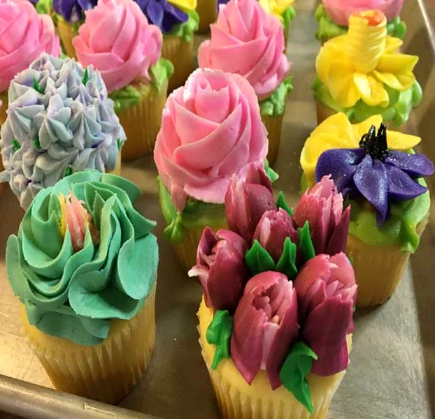 Cupcakes piped with buttercream roses and tulips