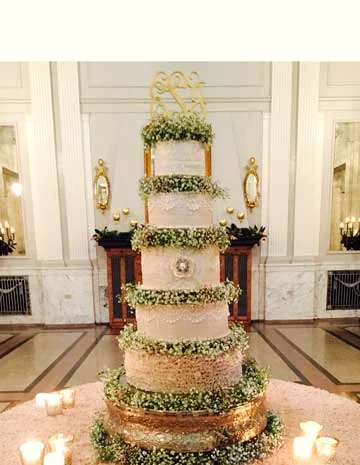 Tall wedding cake with baby’s breath at a marble reception hall