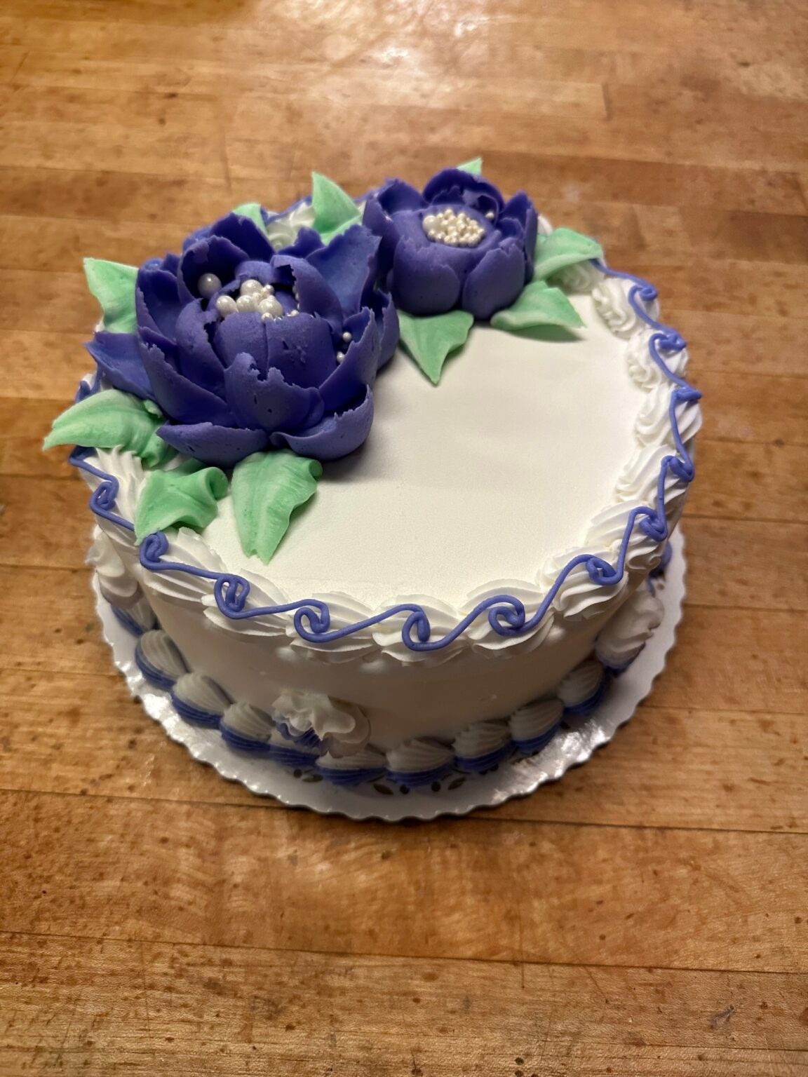 White cake with purple buttercream water lilies