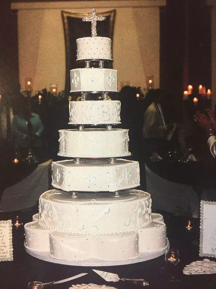 Tall pillared wedding cake at a candlelit reception